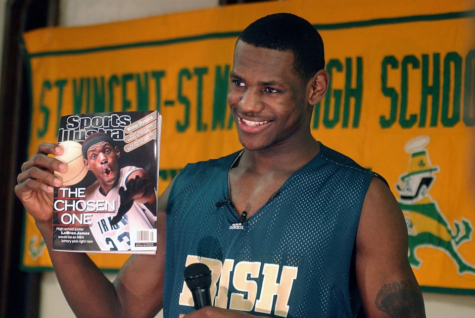 LeBron James holds an issue of Sports Illustrated on Feb. 13, 2002. James was on SI's cover as a junior at St. Vincent-St. Mary High School.