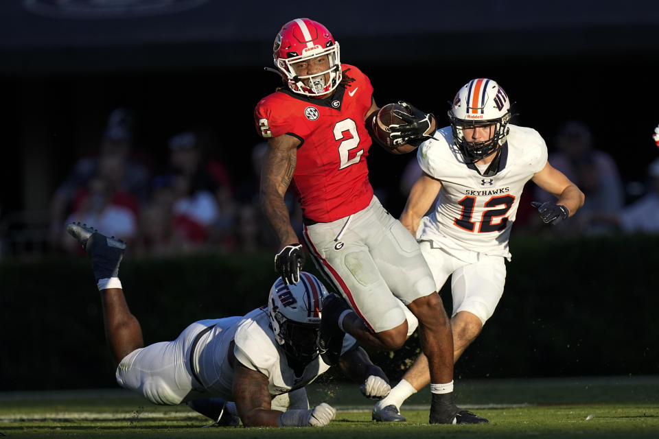 Georgia running back Kendall Milton (2) breaks a way from a Tennessee-Martin defender during the first half of an NCAA college football game Saturday, Sept. 2, 2023, in Athens, Ga. (AP Photo/John Bazemore)