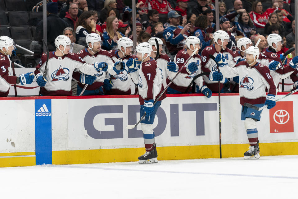 Colorado Avalanche defenseman Devon Toews (7) celebrates with teammates after scoring during the first period of an NHL hockey game, Tuesday, Feb. 13, 2024, in Washington. (AP Photo/Stephanie Scarbrough)