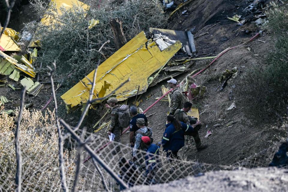 Debris of a Canadair CL-215 firefighting aircraft, which crashed near while being flown to fight a wildfire in Karystos, on the Greek Aegean island of Evia, on July 25, 2023. Two pilots died when their water-bombing plane crashed while battling a blaze on the Greek island of Evia (AFP/Getty)