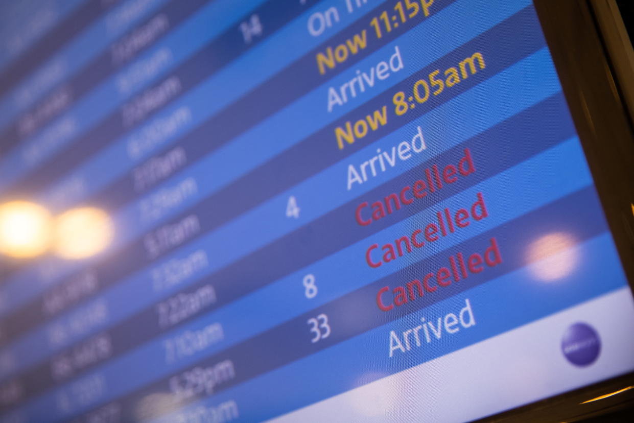A screen showing cancelled flights is seen at John F. Kennedy International Airport in New York City on December 26, 2021. REUTERS/Jeenah Moon