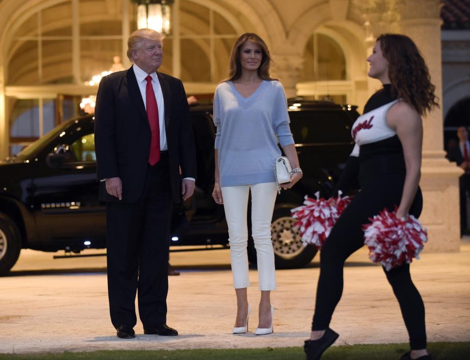 <p>To watch the Super Bowl at a viewing party hosted by her husband, a Patriots fan because of his friendship with Tom Brady and Robert Kraft, Melania Trump dressed in the Palm Beach version of patriotic colors: cropped white pants and light blue sweater (and red blush to complete the look). The Double V-neck felted lambswool sweater in light blue comes from Victoria Beckham and retails for $1,100. She accessorized with Chanel’s classic quilted flap bag in white ($4,495) and matching “So Kate” Christian Louboutin pumps ($695). (Photo: AP) </p>