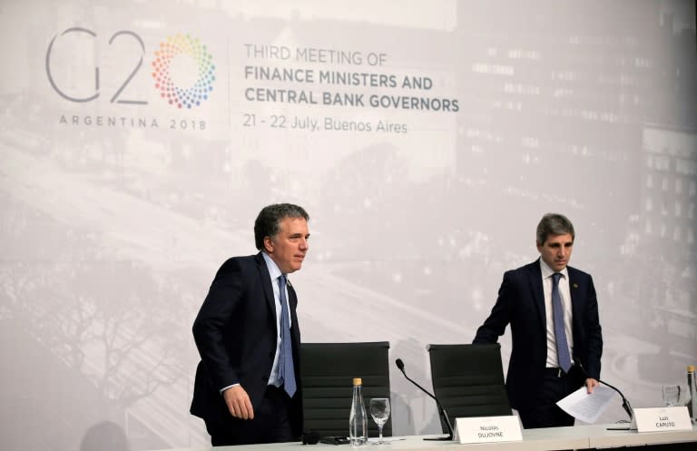 Argentina's Economy Minister Nicolas Dujovne (L), with Central Bank President Luis Caputo, said the group must focus on harmony even amid rising trade tensions
