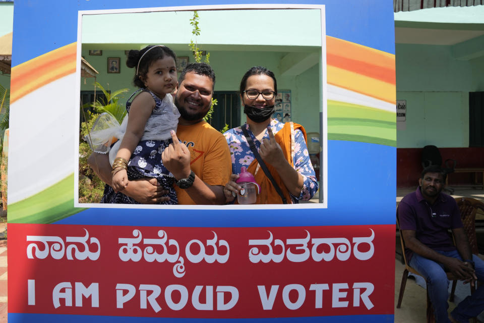 A couple poses for a photograph after casting their votes at a polling station in Bengaluru, India, Wednesday, May 10, 2023. People in the southern Indian state of Karnataka were voting Wednesday in an election where pre-poll surveys showed the opposition Congress party favored over Prime Minister Narendra Modi's governing Hindu nationalist party. (AP Photo/Aijaz Rahi)