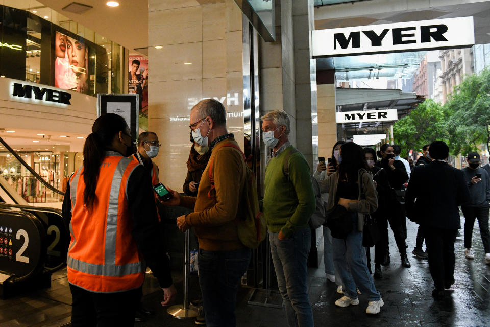 Retail staff ensure shoppers have checked into their store using QR codes in Pitt St Mall, following 108 days of lockdown in Sydney, Monday, October 11, 2021. Source: AAP