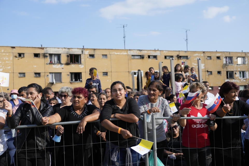 Residents wait for Pope Francis arrival to meet members of the Roma community at Lunik IX, in Kosice, Slovakia, Tuesday, Sept. 14, 2021, the biggest of about 600 shabby, segregated settlements where the poorest 20% of Slovakia's 400,000 Roma live. Pope Francis traveled to Kosice, in the far east of Slovakia on Tuesday to meet with the country's Roma in a gesture of inclusion for the most socially excluded minority group in Slovakia, who have long suffered discrimination, marginalization and poverty. (AP Photo/Gregorio Borgia)