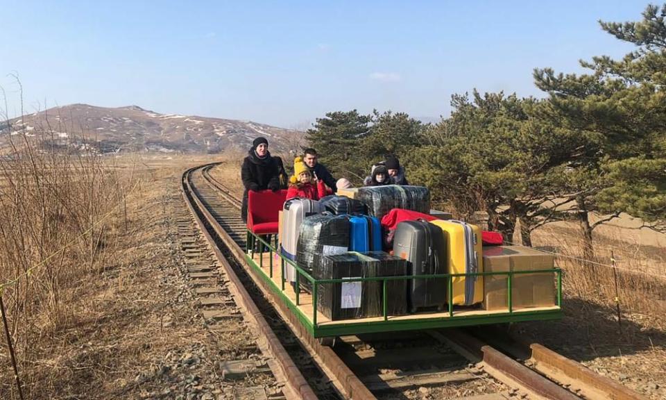 Staff members of the Russian embassy in North Korea and their family members use a hand-pushed rail trolley as they travel from the Russian border station of Khasan in the Russian Far East during their journey from North Korea. The diplomats and their family members made a 32-hour train journey and a two hour bus ride in North Korea, and then crossed the border to Russia using the rail trolley.