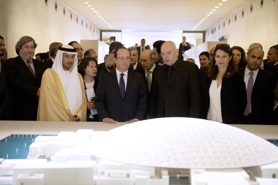 French President Francois Hollande, center left, Sheikh Sultan Bin Tahnoon Al Nathyan, Abu Dhabi authority president for tourism and culture, left, French architect Jean Nouvel, center right, and French Culture Minister Aurelie Filippetti, right, visit the exhibition 'Birth of a Museum', at the Louvre museum Tuesday, April 29, 2014, in Paris. The 'Birth of a Museum' exposition presents paintings, sculptures, and other artworks that the famous French Louvre museum will send to the new Louvre museum branch in Abu Dhabi, in the United Arab Emirates, and which is expected to open in 2015. (AP Photo/Alain Jocard, Pool)