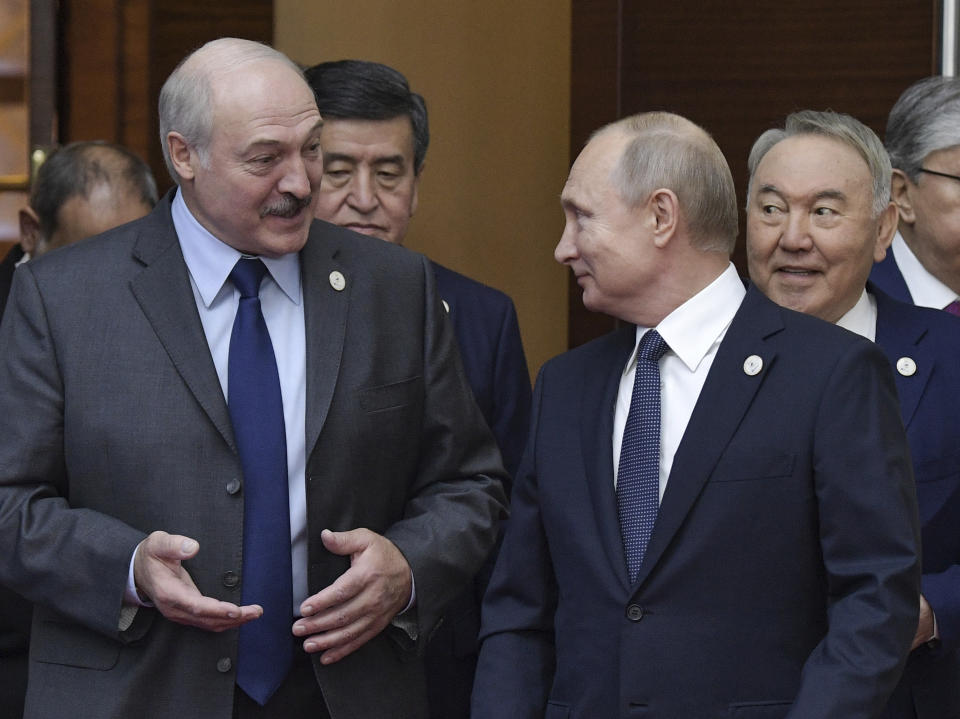 FILE In this file photo taken on Wednesday, May 29, 2019, Russian President Vladimir Putin, right, and Belarusian President Alexander Lukashenko talk to each other ahead of the Supreme Eurasian Economic Council meeting in Nur-Sultan, the capital city of Kazakhstan. Russian President Vladimir Putin prepares to mark his 20th year in power, as the longest-serving leader since Joseph Stalin. (Alexei Nikolsky, Sputnik, Kremlin Pool Photo via AP, File)