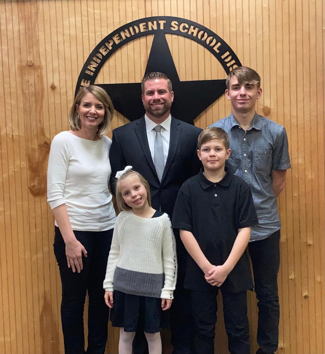 New Howe head football coach and athletic director Lance Bryan, along with the his wife Erika and children, clockwise, Parker, Ty, and Callie, were at the Howe ISD school board meeting for his hiring.