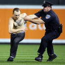 A Baltimore police oficer takes down a fan who ran onto the field during the game. The Boston Red Sox visited the Baltimore Orioles in an MLB regular season game at Camden Yards. (Photo by Jim Davis/Globe Staff)