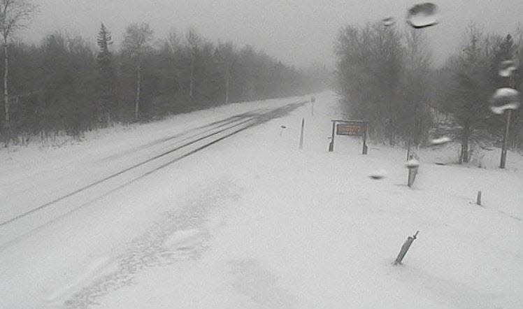 Snow covers the roadway on M-64 near County Park Road in Bergland Township on Wednesday, April 3, 2024.