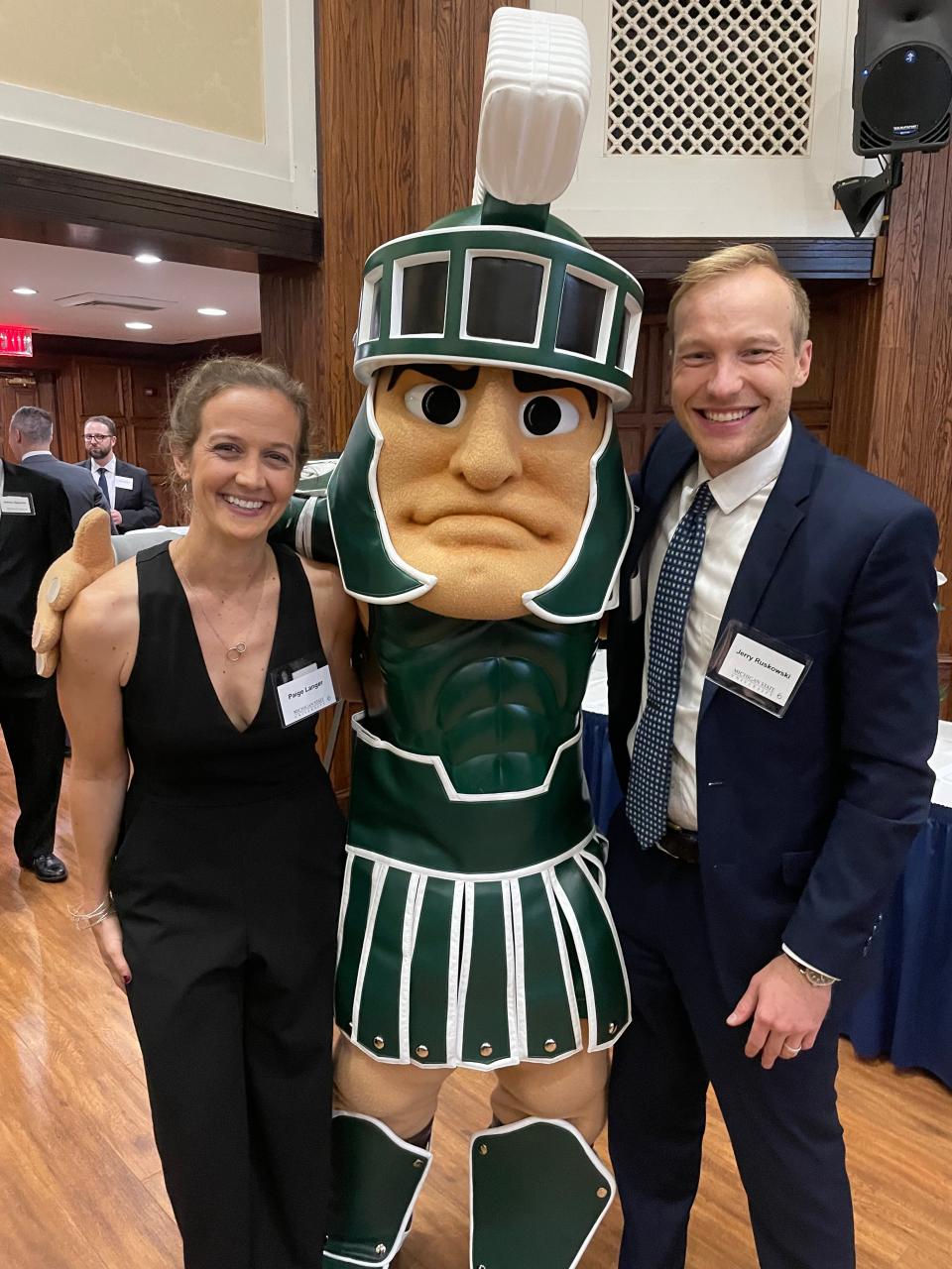Jerry Ruskowski and his wife, Paige Langer, pose with Sparty, Michigan State University's mascot.
