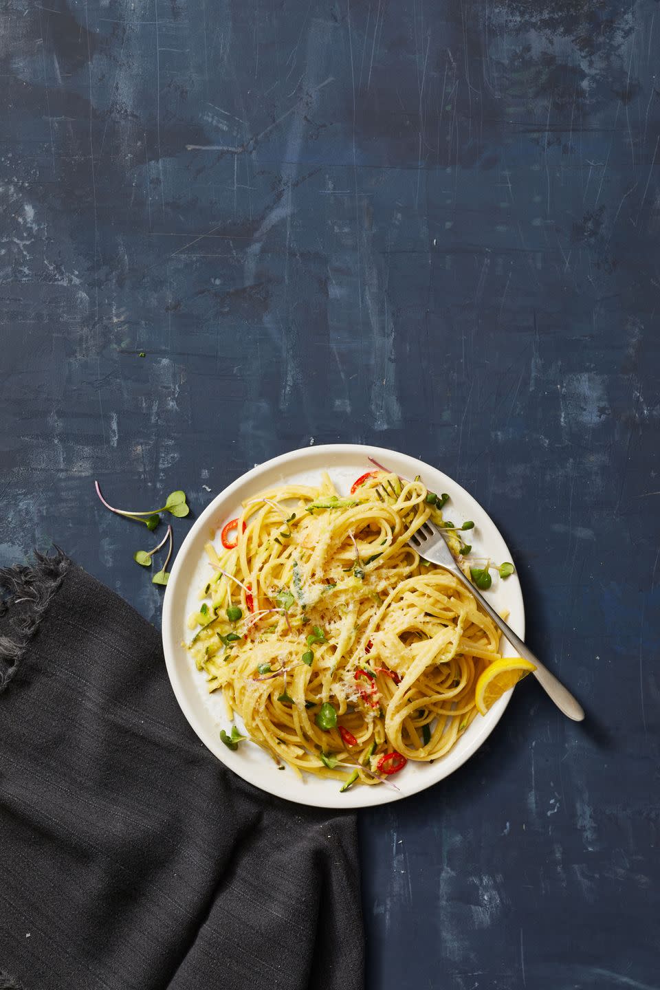 a plate of zucchini linguine on a white plate