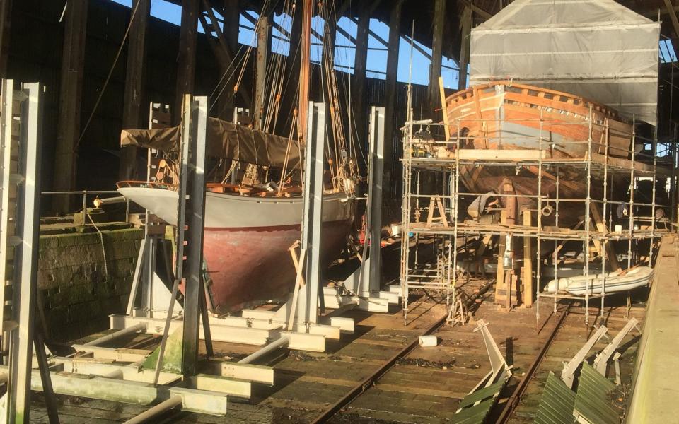 Two boats undergoing work at No 1 Covered Slip, which dates back to 1763 - Robert Darch 