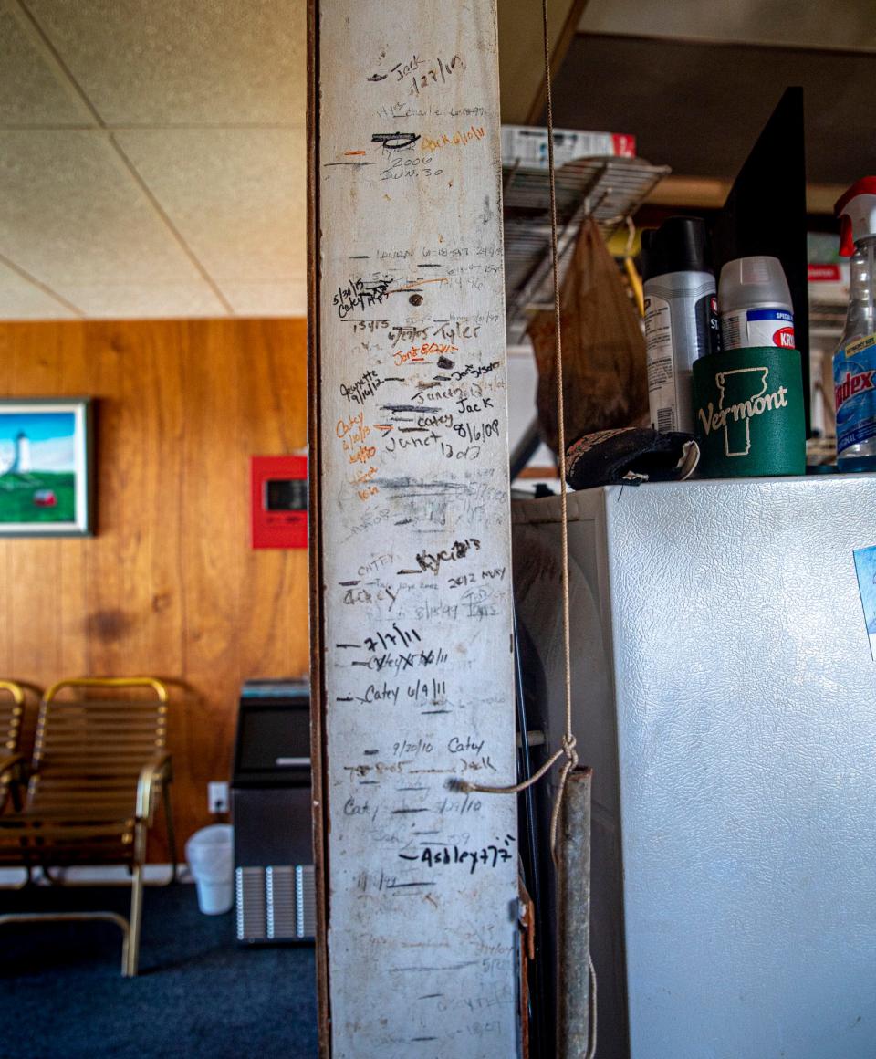 The heights of three generations of Paul de la Pena's family who have grown up owning and working in the Nevada Motel on Long Beach Avenue in York, Maine, are seen July 28, 2021, on the wall of the iconic motel which was recently put up for sale.