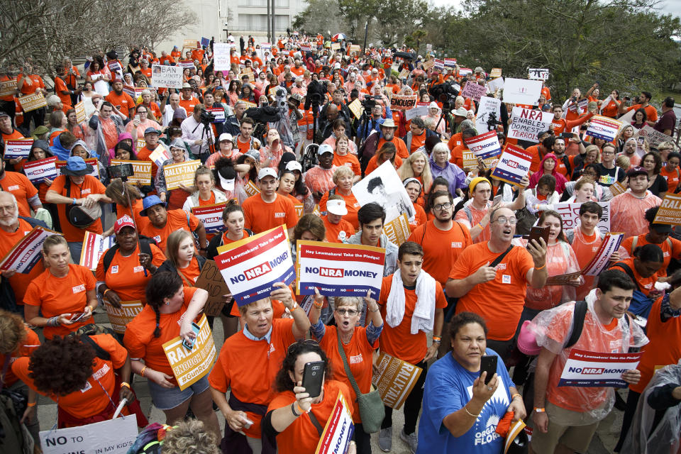 Activists hold up signs at the Florida State Capitol as they rally for gun reform legislation in Tallahassee, Fla., on Feb. 26, 2018.