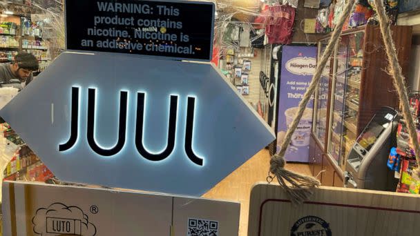 PHOTO: A Juul electronic cigarette sign hangs in the front window of a bodega convenience store in New York City on June 25, 2022. (Ted Shaffrey/AP, FILE)