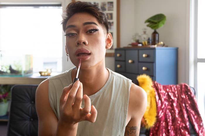 Man applying drag queen makeup at home