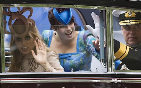 Princesses Beatrice and Eugenie lost their Met police protection in 2011, the year of the Duke and Duchess of Cambridges' wedding, where they are pictured with their father the Duke of York - Credit: Warren Allott/AFP