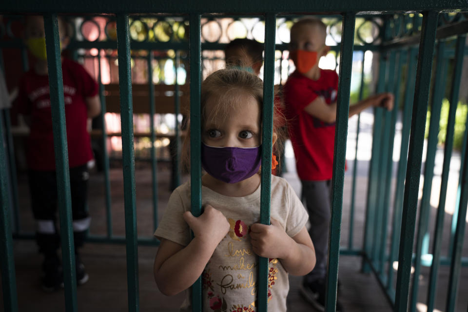 Zayla LeClair, 3, waits to ride a train at Adventure City amusement park on the day of reopening in Anaheim, Calif., Friday, April 16, 2021. The family-run amusement park that had been shut since March last year because of the coronavirus pandemic reopened on April 16. (AP Photo/Jae C. Hong)