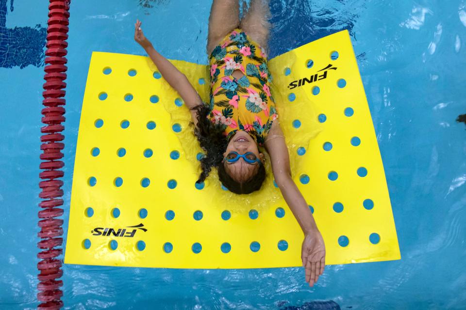 Sarai Westbrook, 12, practices her backstroke during a free swim lesson with instructor Brian Botzman at the Columbus School for Girls pool in Columbus, Ohio June 21.  Botzman is offering the free lessons to help kids become more confident and safe during aquatic recreation.