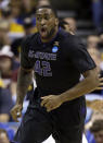 Kansas State's Thomas Gipson celebrates after making a basket during the first half of a second-round game against Kentucky in the NCAA college basketball tournament Friday, March 21, 2014, in St. Louis. (AP Photo/Jeff Roberson)