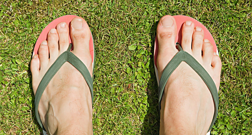 Man's feet in thongs