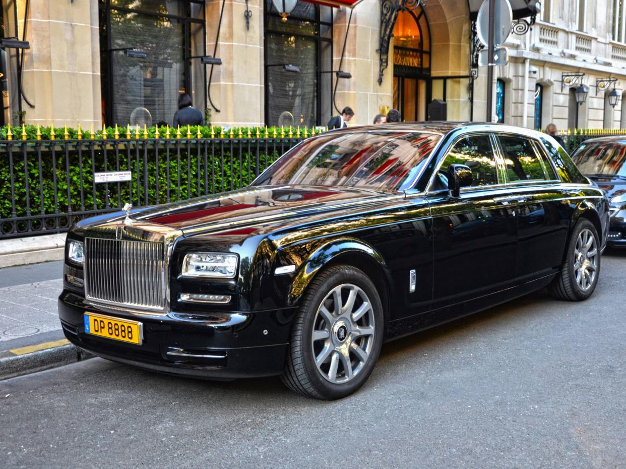 Paris, France-April 18th 2015: Half-face Black Rolls Royce Phantom parked in a street, in George V quarter.