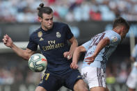 Real Madrid's Gareth Bale, left, challenges for the ball with Celta Vigo's Kevin Vazquez during La Liga soccer match between Celta and Real Madrid at the Balaídos Stadium in Vigo, Spain, Saturday, Aug. 17, 2019. (AP Photo/Luis Vieira)