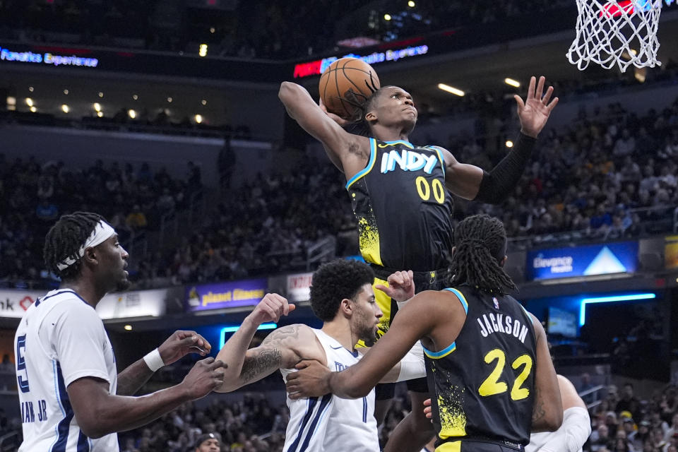 CORRECTS PLAYER TO GRIZZLIES GUARD SCOTTY PIPPEN JR. INSTEAD OF FORWARD OBI TOPPIN - Indiana Pacers guard Bennedict Mathurin (00) shoots over Memphis Grizzlies guard Scotty Pippen Jr. (1) during the first half of an NBA basketball game in Indianapolis, Sunday, Jan. 28, 2024. (AP Photo/Michael Conroy)