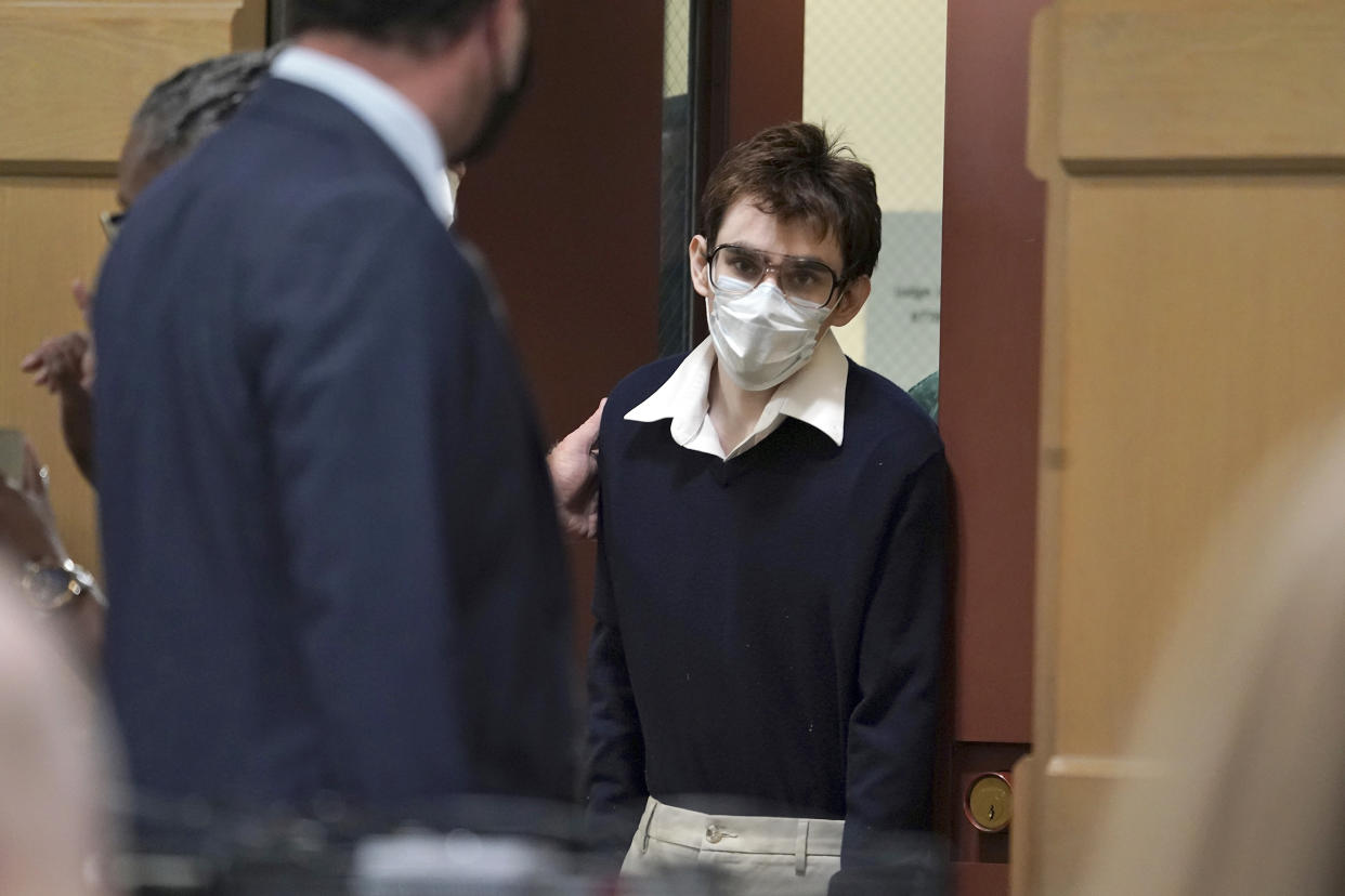 Parkland school shooter Nikolas Cruz enters the courtroom before pleading guilty, Friday, Oct. 15, 2021,  at the Broward County Courthouse in Fort Lauderdale, Fla., on all four criminal counts stemming from his attack on a Broward County jail guard in November 2018,  Cruz's lawyers said Friday that he plans to plead guilty to the 2018 massacre at a Parkland high school. (Amy Beth Bennett/South Florida Sun Sentinel via AP, Pool)