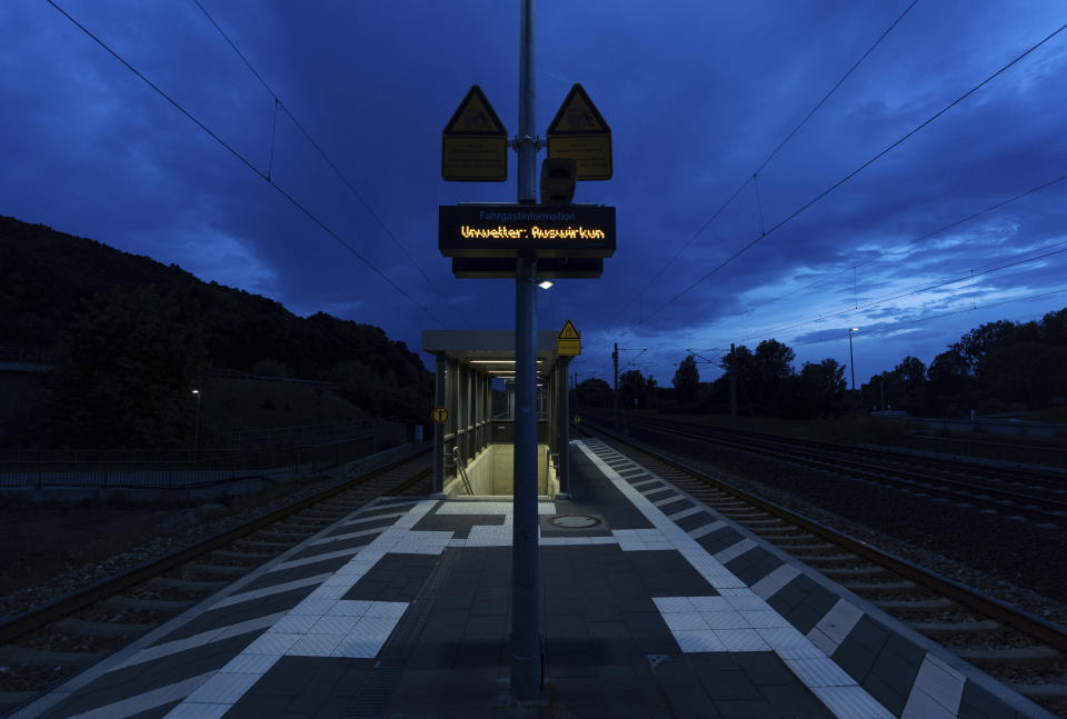 The words "Unwetter" (severe weather) are displayed on a display panel on a train platform, in Ebing, Germany, Friday, May 20, 202. The German Weather Service (DWD) expects thunderstorms for parts of Bavaria in the evening hours. (Nicolas Armer/dpa via AP)