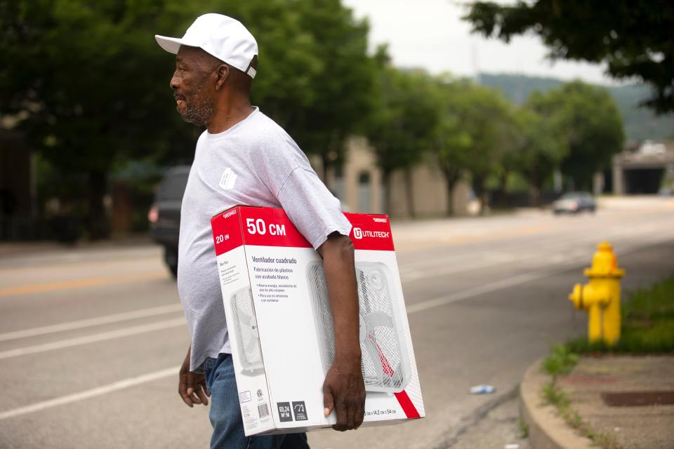 Jimmie Martin, 69, West End, heads home across Bank Street after picking up a fan from Society of St. Vince de Paul, Monday, June 13, 2022. Martin said his home does not have air conditioning, so the fan is vital. Temperatures will be in the 90's this week with a heat index over 100 degrees. Kristen Gallagher, marketing and communications, said since May 1, theyÕve already given out 679 fans and 197 air conditioning units.
