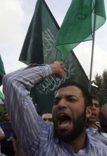 Supporters of the Sunni Muslim Jamaa Islamiya group shout slogans during a rally in central Beirut. The violence erupted hours after reports emerged that troops had shot dead Sheikh Ahmad Abdul Wahid, a prominent anti-Syria Sunni cleric, when his convoy failed to stop at a checkpoint in north Lebanon on Sunday. Another cleric in the car was also killed