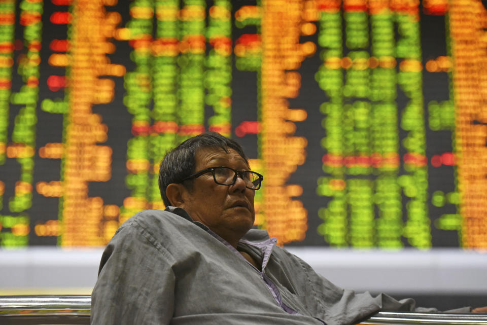 Investor sits at private stock trading boards at a private stock market gallery in Kuala Lumpur, Malaysia, Tuesday, Oct. 16, 2018. Asian markets were mostly higher on Tuesday, though Chinese benchmarks fell after the government reported inflation rose for the fourth straight month. (AP Photo/Yam G-Jun)
