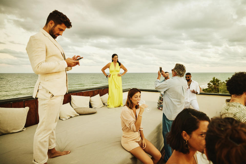 a bridal party taking photos by the water