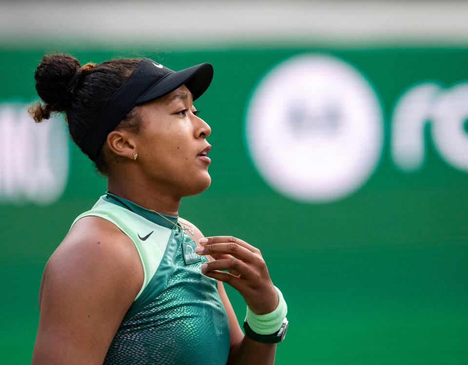 Naomi Osaka rubs her necklace between serves against Sara Errani during round one of the BNP Paribas Open in Indian Wells, Calif., Thursday, March 7, 2024.