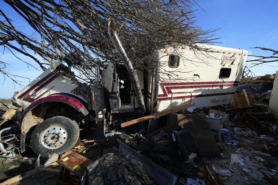 A semi truck is seen on top of the home of Lonnie and Melissa Pierce, who were killed when the truck landed on their house during a tornado that hit three days earlier, Monday, March 27, 2023, in Rolling Fork, Miss. (AP Photo/Julio Cortez)