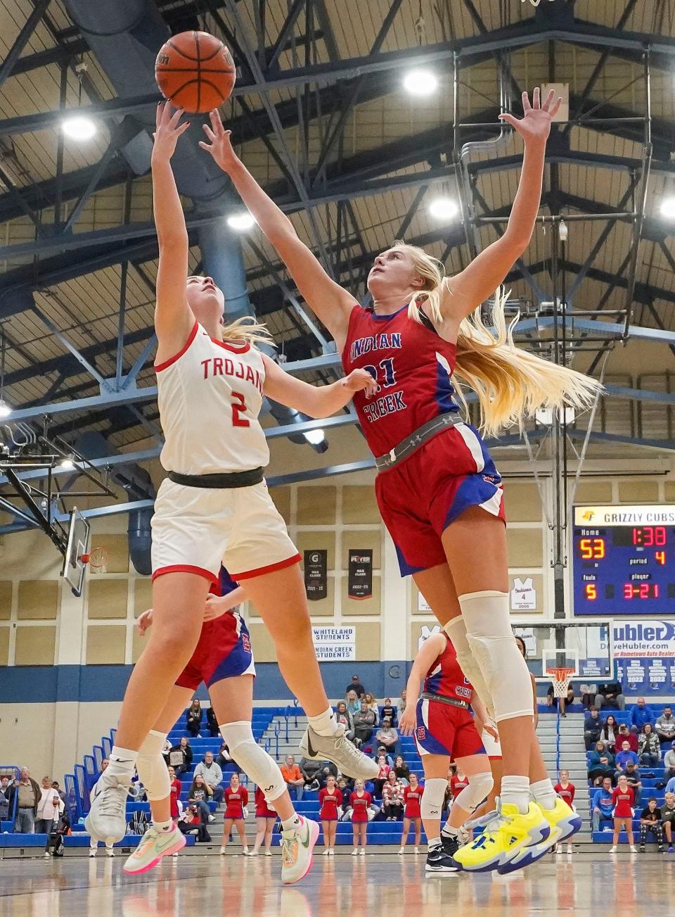Center Grove Trojans Audrey Annee (2) attempts a lay-up against Indian Creek Faith Wiseman (21) on Thursday, Nov. 16, 2023, during the semifinals of the Johnson County Tournament at Franklin Community High School in Franklin. The Center Grove Trojans defeated Indian Creek, 61-52.