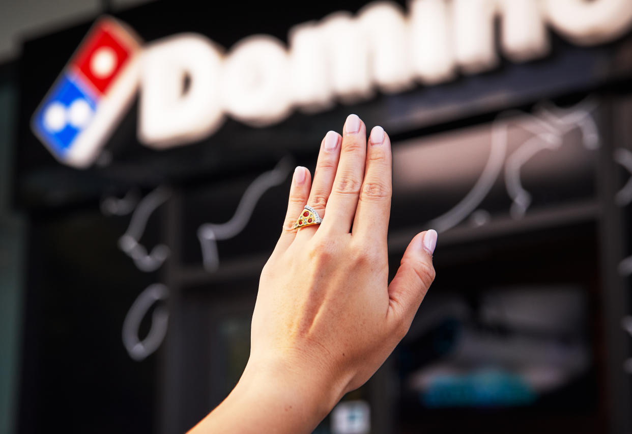 A female hand wearing Domino's Australia's pizza engagement ring