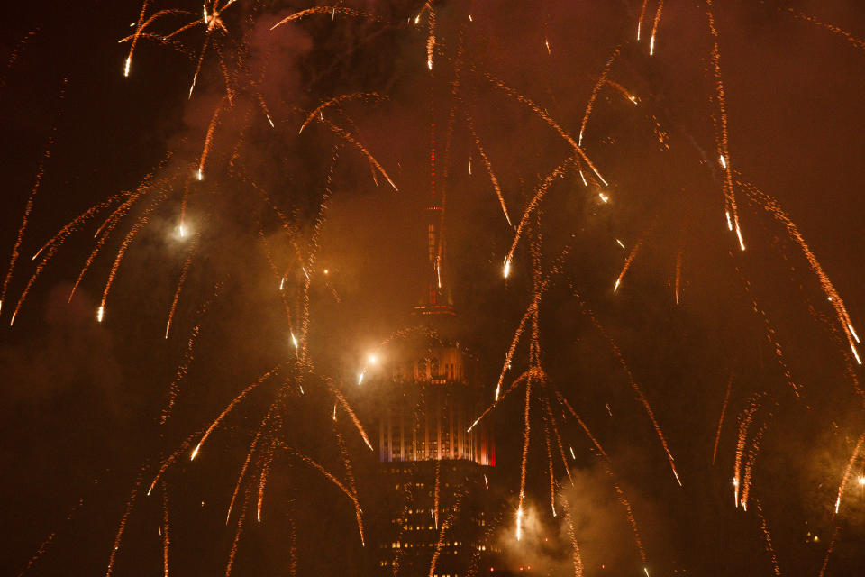 <p>With the Empire State Building in the background fireworks explode during an Independence Day show over the East River, Wednesday, July 4, 2018, in New York. (Photo: Andres Kudacki/AP) </p>