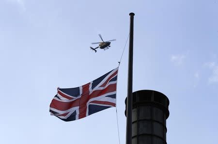 A helicopter flies over a Union Flag at half-mast in Westminster the day after an attack, in London, Britain March 23, 2017. REUTERS/Stefan Wermuth