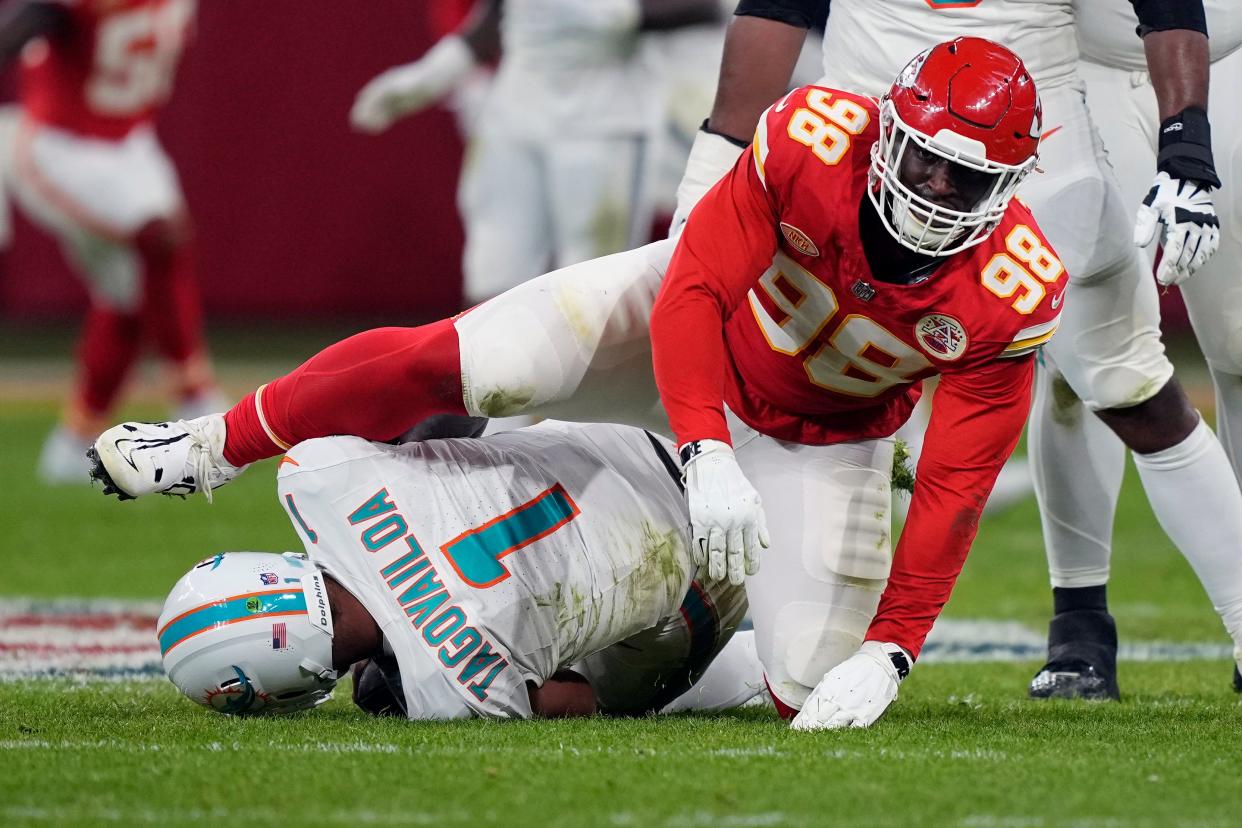 Miami Dolphins quarterback Tua Tagovailoa (1) is sacked for an 11-yard loss by Kansas City Chiefs defensive tackle Tershawn Wharton (98) during the second half of an NFL football game Sunday, Nov. 5, 2023, in Frankfurt, Germany. (AP Photo/Martin Meissner)