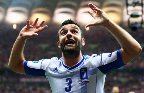 Giorgos Tzavelas of Greece celebrates victory and progress to the quarter finals during the UEFA EURO 2012 group A match between Greece and Russia at The National Stadium on June 16, 2012 in Warsaw, Poland. (Photo by Shaun Botterill/Getty Images)