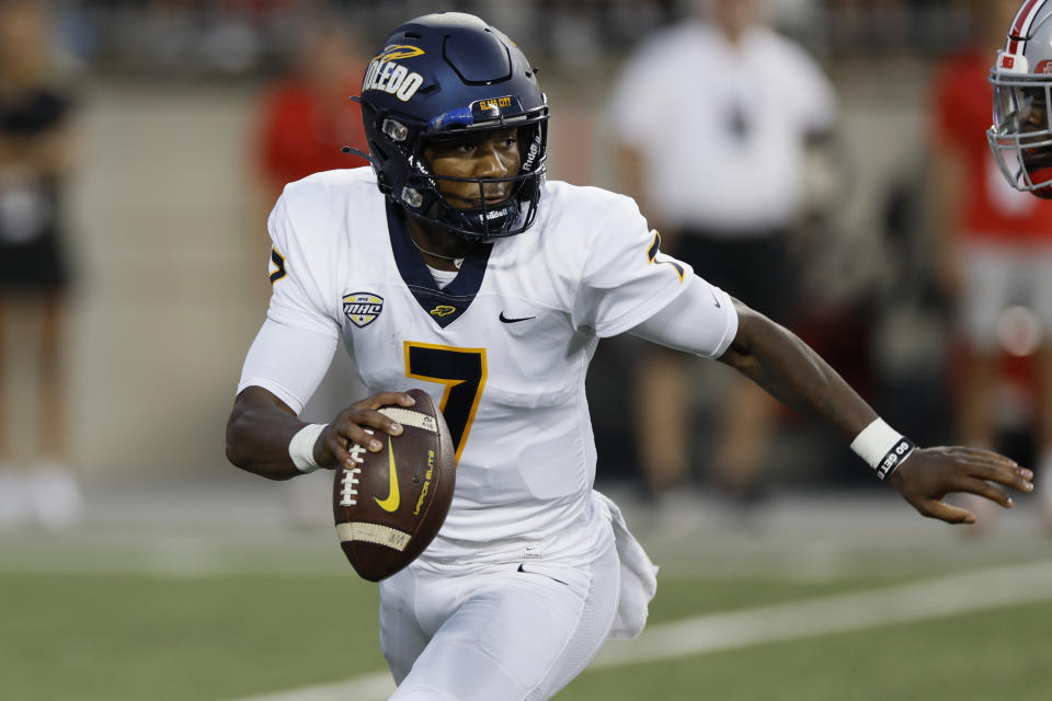 FILE - Toledo quarterback Dequan Finn scrambles in the backfield during the first half of the team's NCAA college football game against Ohio Stat, Saturday, Sept. 17, 2022, in Columbus, Ohio. Finn will try to improve on last season's second-team all-MAC honors after throwing 23 TD passes and rushing for 631 yards. (AP Photo/Jay LaPrete, File)