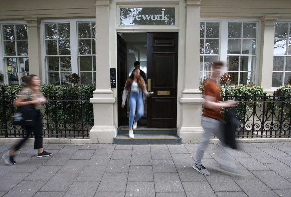 Signage outside the co-working office space group, WeWork, at Soho Square,London.