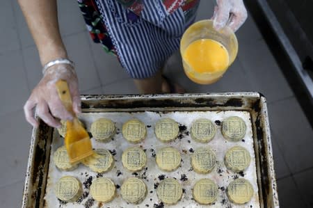 An employee makes mooncakes with anti-extradition bill slogans at Wah Yee Tang Bakery in Hong Kong