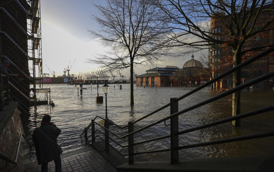 The fish market is flooded during a storm surge in Hamburg, Germany, Friday Dec. 22, 2023. Pre-Christmas rail travelers in parts of Germany faced widespread disruption on Friday as a storm swept across northern Europe, bringing down trees and prompting warnings of flooding on the North Sea coast. (Christian Charisius/dpa via AP)