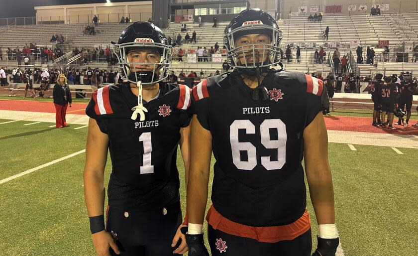 Steven Perez, left, and Salvador Zamora pose for a photo after Banning's defeat of Dorsey on Friday night.